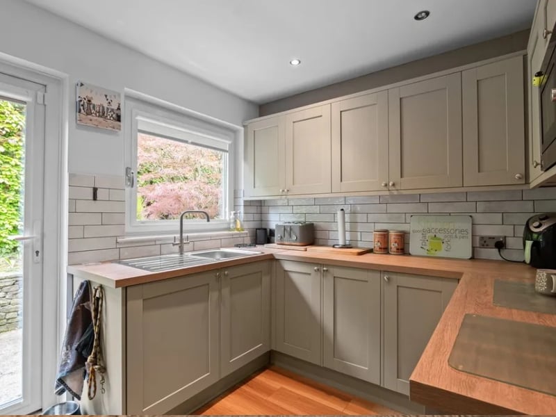 Williams & Co Estate Agents writes: "The kitchen has been thoughtfully fitted with shaker-style cabinetry, wooden worktops and a classic metro tiled splashback, with a window overlooking the rear garden providing a pleasant aspect whilst cooking."