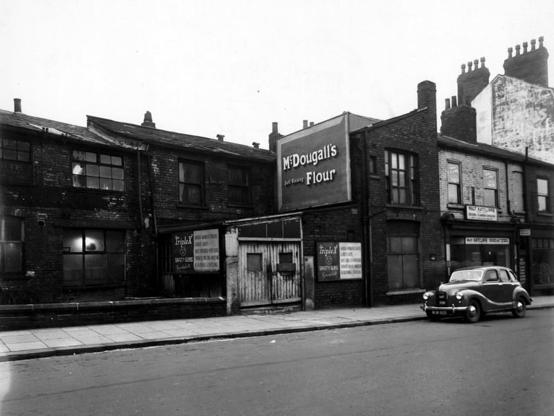 A view of the nrth side of Merrion Street showing Nos. 60 to 64, which are TripleX Safety Glass and Walt Radcliffe, Building Contractors. Billboards for McDougalls Self Raising Flour. Pictured in December 1949.