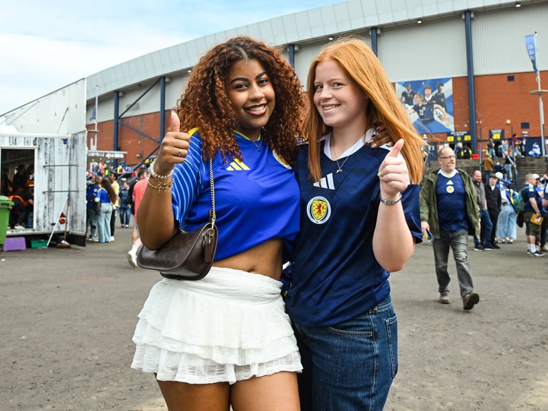 A Curacao fan and a Scotland fan pose for a photo ahead of the game.