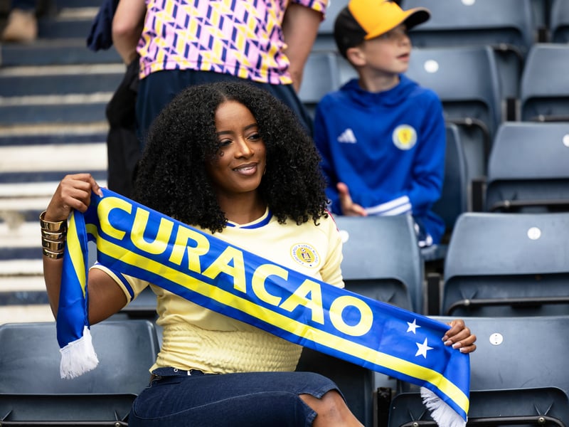 A Curacao fans shows her colours ahead of the game vs Scotland.