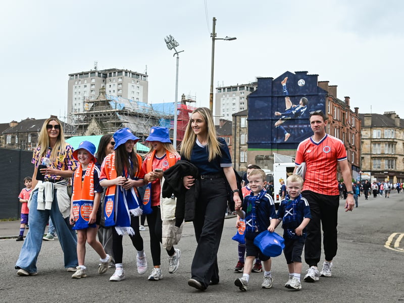 A family of Scotland fans make their way to Hampden.