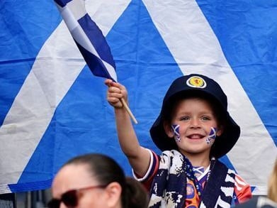 A young Scotland fan wave the saltire ahead of the game against Curacao at Hampden.