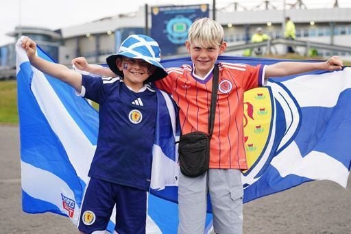 Two young fans show their support for the team ahead of kick-off against Curacao.