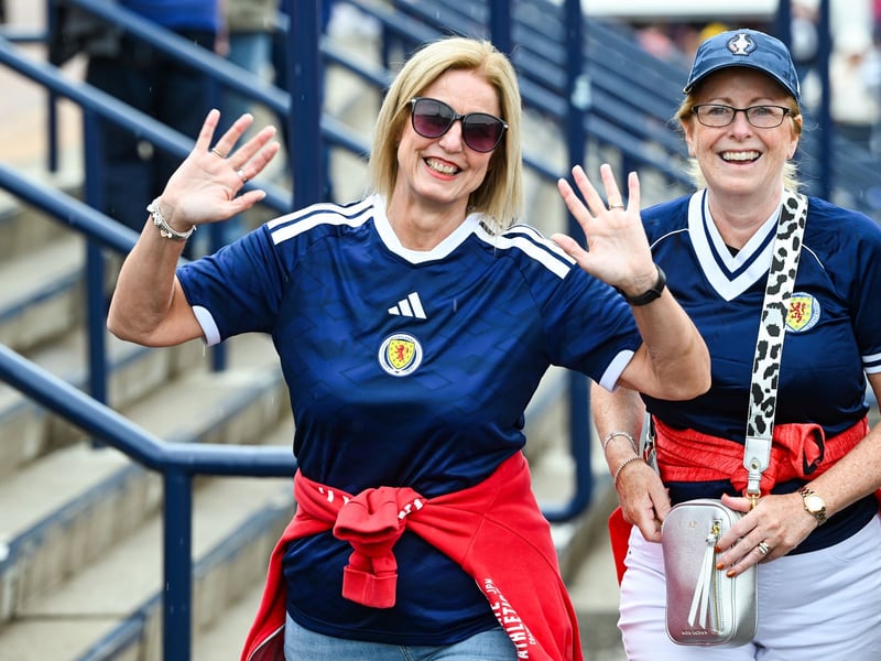Two fans wave for the camera.