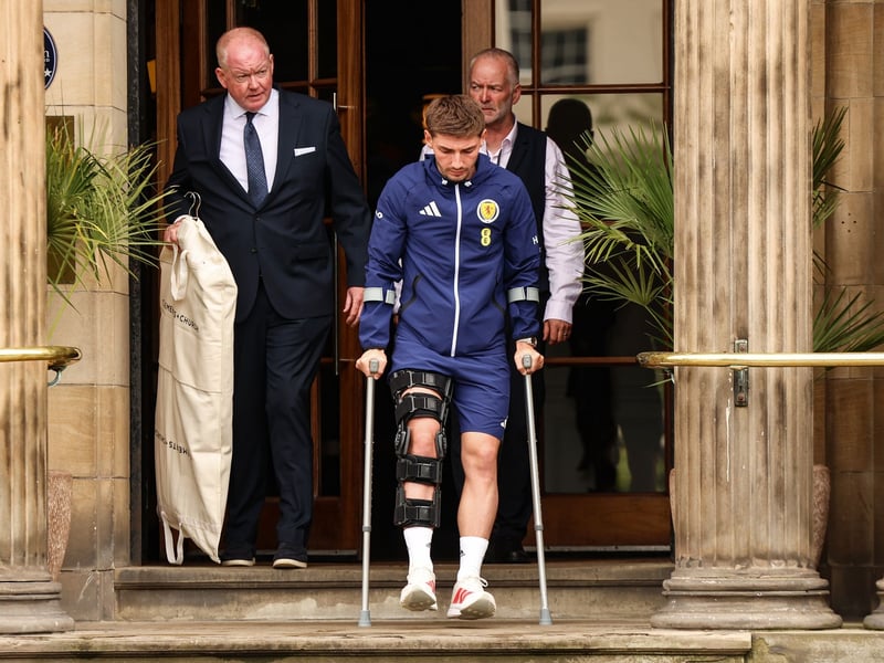 Billy Gilmour leaves the Blythswood Square Hotel on crutches after being ruled out of the World Cup with a knee injury picked up against Curacao the previous day.