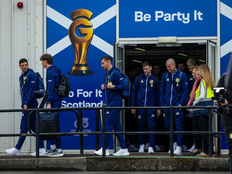The Scotland squad prepare to board the plane for Florida from Glasgow Airport.