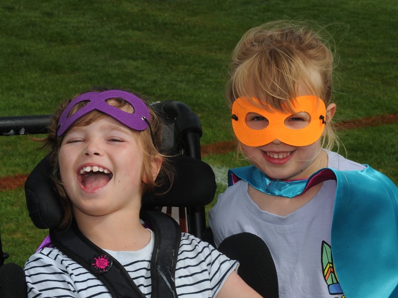 Eight-year-old Olive and six-year-old Etta put on their best superhero masks for the occasion