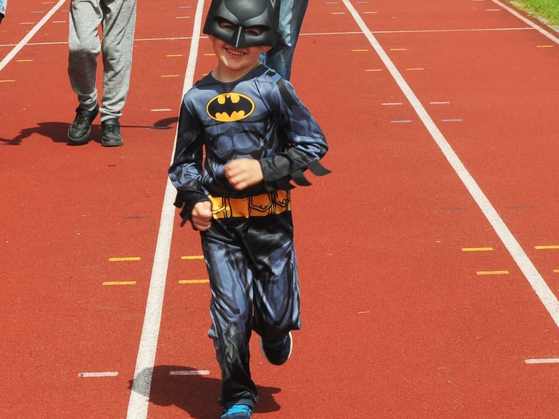 Four-year-old Zach nearing the finish line as Batman