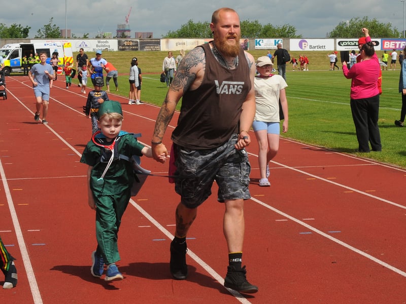 The challenge sees families walk, run, or wheel along a 400m track