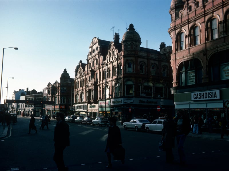 Shops on Vicar Lane in Jauary 1976. On the right is Cashdisia, ladies, mens and childrens wear, then after the junction with Queen Victoria Street are Peter Eastwood menswear, Wigfalls TV and electrical, Halfords cycle and car accessories and John Collier tailor. Next is the junction with King Edward Street then the Famous Army Stores.