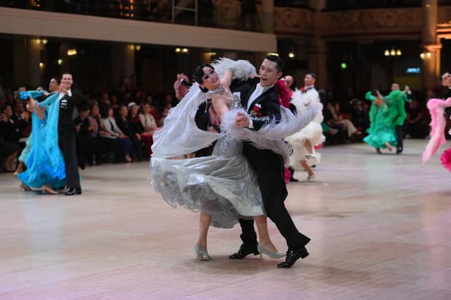 Dancers dressed in elegant ballroom attire take to the floor on the final day of the 100th Blackpool Dance Festival at the Empress Ballroom, Winter Gardens Blackpool.