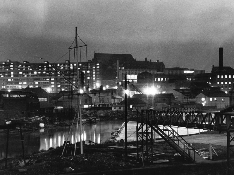 Looking from Crown Point Bridge, Leeds, across the River Aire towards the flats of Saxton Gardens in January 1966.