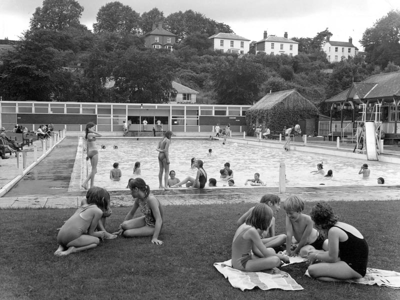 A summer scene from 1972 showing Market Drayton's outdoor swimming pool, a popular spot for local families and youngsters during the warmer months. For many residents, days spent by the pool remain a treasured memory of summers gone by.