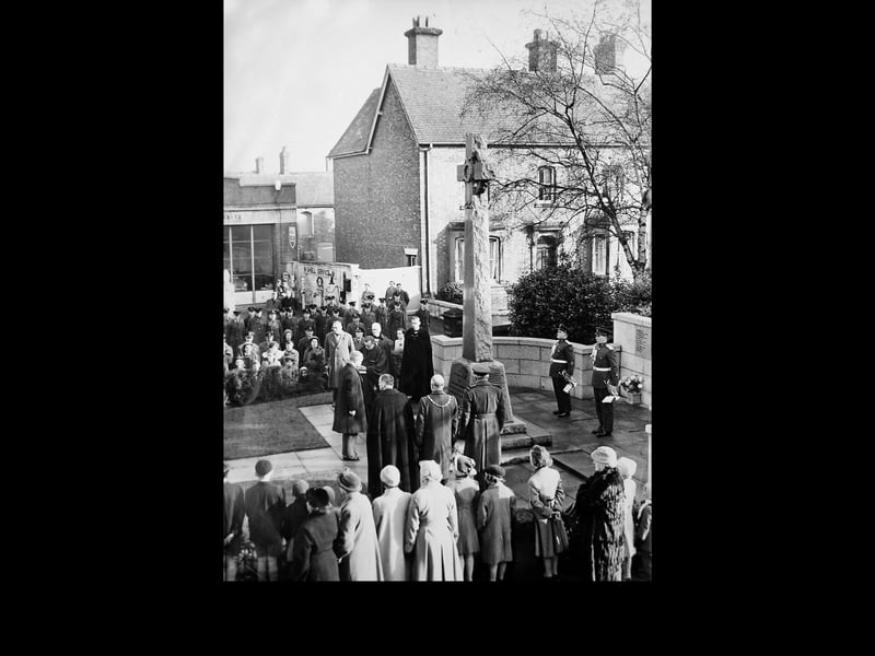A Remembrance Sunday service in Market Drayton, showing residents gathered at the town's war memorial to honour those who gave their lives in conflict. The undated photograph, thought to date from the 1960s, captures a moment of reflection and remembrance that has long been part of the town's traditions.