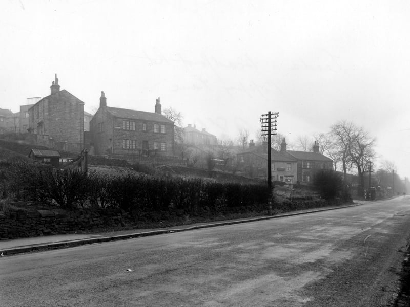 Looking south west along Leeds and Bradford Road. Coppy Lane can be seen leading off to the left with a police phone box on the corner. Pictured in December 1954.