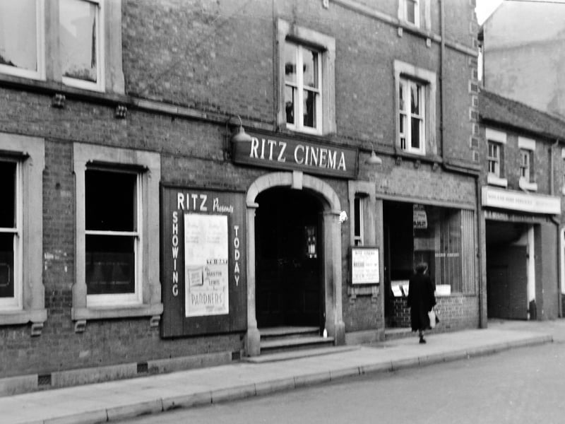 The Ritz Cinema on Cheshire Street, Market Drayton, pictured in the mid-1950s. The cinema is advertising Pardners starring Martin and Lewis, released in 1956, suggesting the image dates from around that time or shortly after. A classic town centre scene from the golden age of cinema-going.