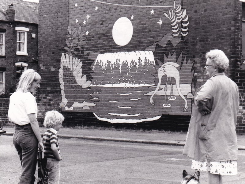 August 1981 and neighbours look at a blaze of colour from the end of a row of houses on Cow Close Road. The mural of a crocodile and a flamingo in front of a waterfall with a rocket flying overhead was next to the New Blackpool Centre of the Red Ladder Theatre Co. Ltd. 