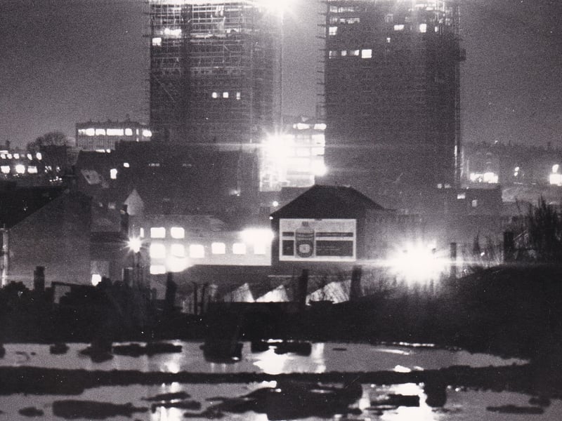Like beacons in the sky are floodlights fixed on new blocks of flats which were being built at Lovell Road off North Street in December 1965. They allowed work on the site to continue after dark. This photo, taken from Dolly Lane, shows the lights reflected in pools after heavy rain.