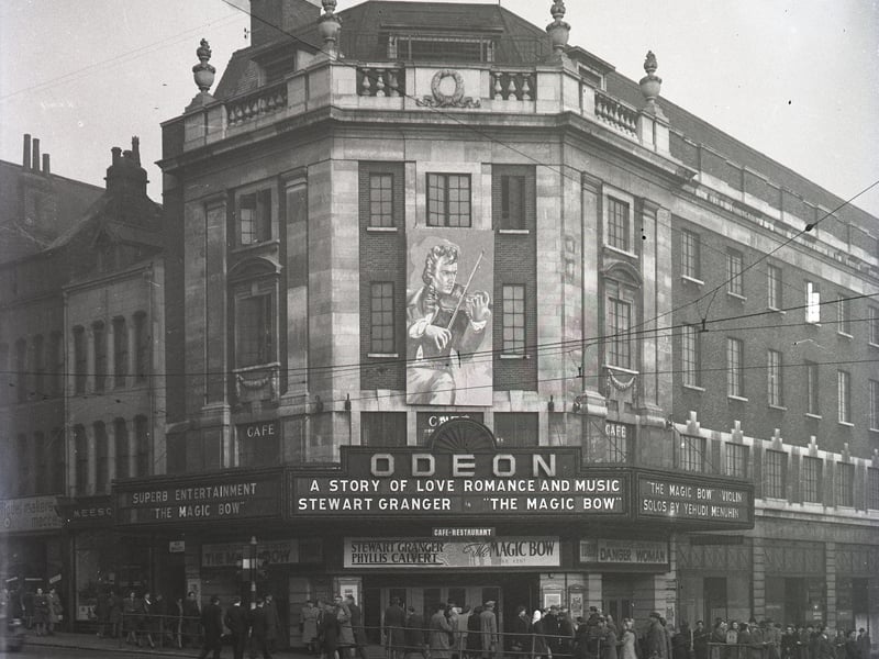 Odeon cinema & cafe-restaurant on The Headrow,. It was showing 'The Magic Bow' film featuring Stewart Granger and Phyllis Calvert, with violin solos by Yehudi Menuhin. Tram tracks run along Briggate and next door on the right are Mecca Models and Meesons.
