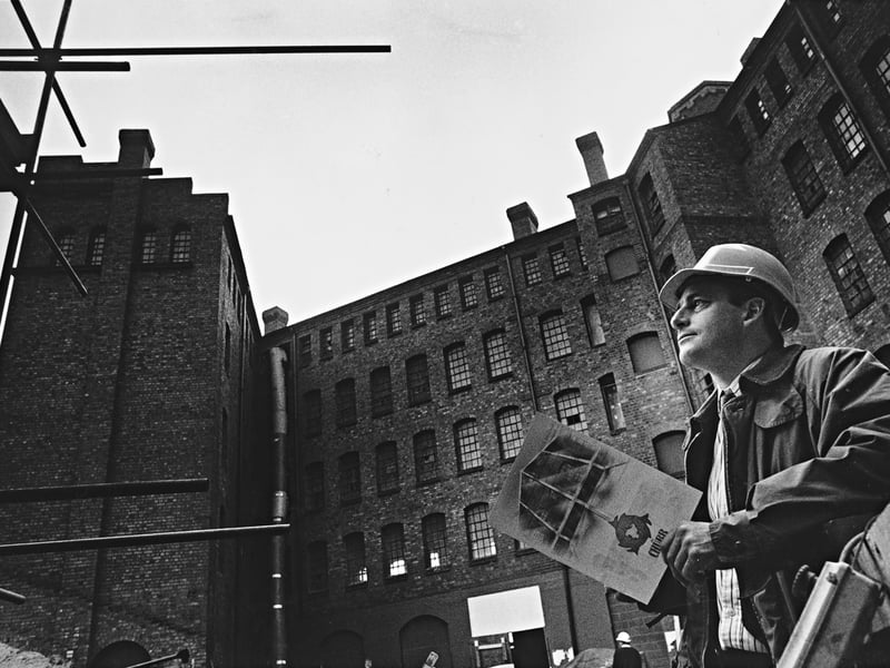 Peter White, general manager of the Midlands Industrial Association, holding project plans as he inspects scaffolding during the ambitious redevelopment of the historic Chubb lock works in October 1990. Following years of disuse, huge sums were invested into sandblasting, structural restoration, and converting the towering brick complex on Railway Drive in Wolverhampton into trendy, upmarket offices with a distinct heritage feel. Do you remember visiting the Chubb Buildings during its 1990s transformation into creative workspaces and venue space?