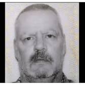John is described as 5'11" in height, with grey hair and of a slim build
