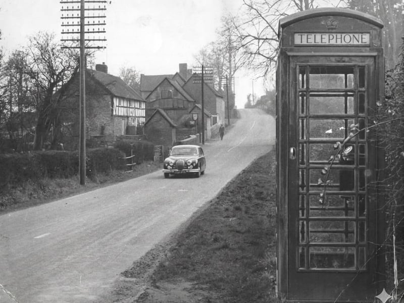 A striking 1960 view of Richards Castle, where a humble telephone kiosk stands on the boundary between Shropshire and Herefordshire near Ludlow. Dated March 1960, the image reflects local debate at the time over proposed changes to the county border, with the village caught between two identities. Once described as a line that might “claim” the community for Shropshire, the boundary issue clearly stirred strong feelings among residents. 