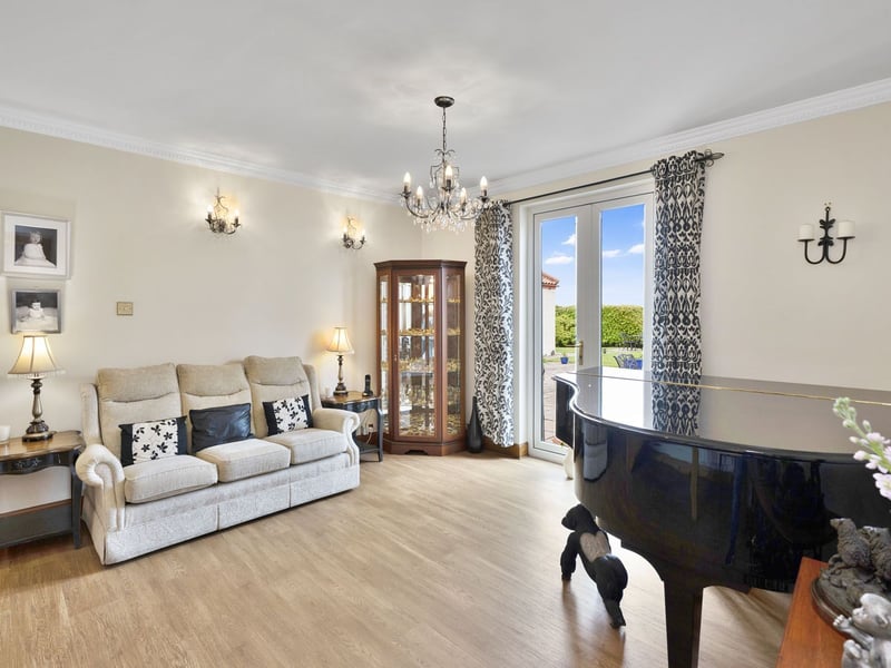 Next door is a second reception area which could be used as a dining room or as a family/music room. It has spacious dimensions and French doors, extending out into the garden for summer soirees.
