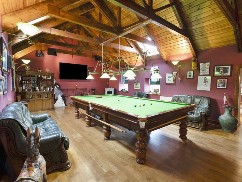 Another standout feature is the dedicated snooker room, measuring an impressive 43 square metres. Like the swimming pool, a double-height ceiling and dual-aspect windows add to the scale of this exceptional space.