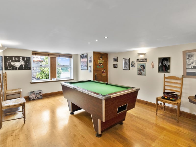 There is also this large games room, with good storage space. Extras: all fitted floor and window coverings, light fittings, an electric range cooker, an integrated dishwasher, an American-style fridge/freezer, a washing machine, and a tumble dryer to be included in the sale. 