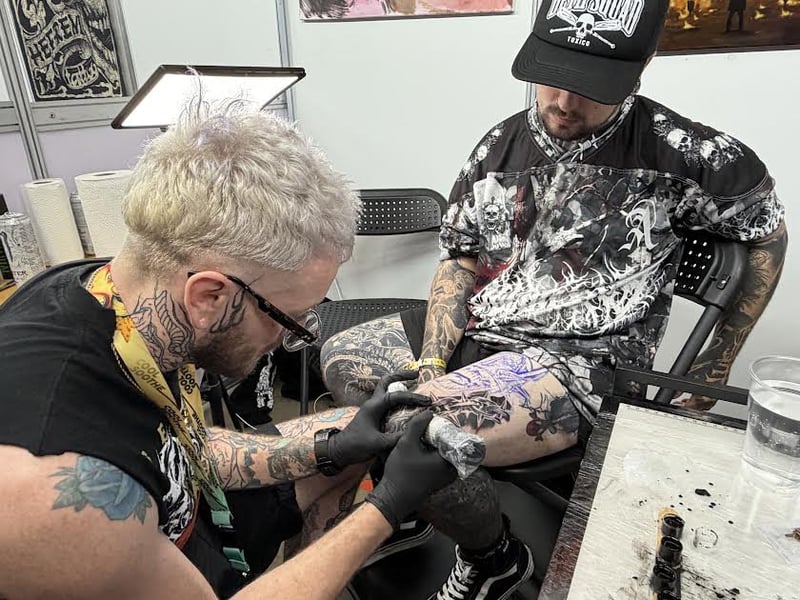Tattooist Bradley Thompson of Warrington working on a big tattoo for Miles Edwards.