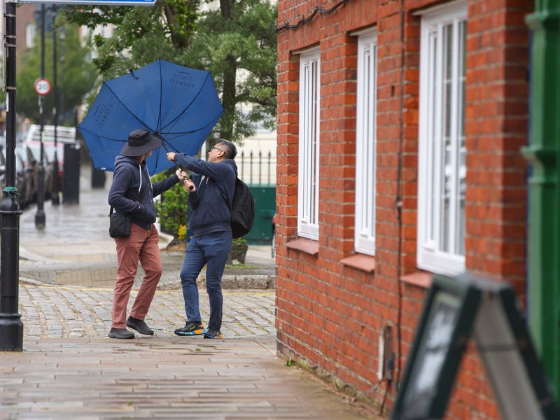 Brolly trouble in the High Street. Wild weather on Saturday morning in Old Portsmouth
Picture: Chris Moorhouse (060626-16)
