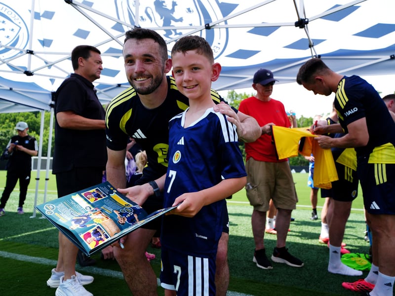 Sheltering from the sun, McGinn poses with a fan. 
