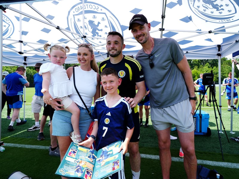 In a break from training, McGinn poses with fans. 
