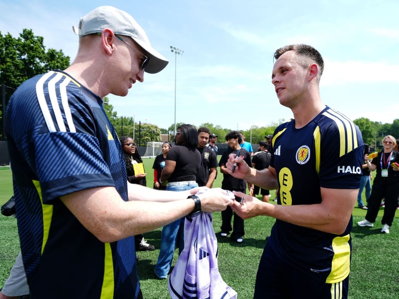 Scotland's Lawrence Shankland (right) signs autographs during a training session.