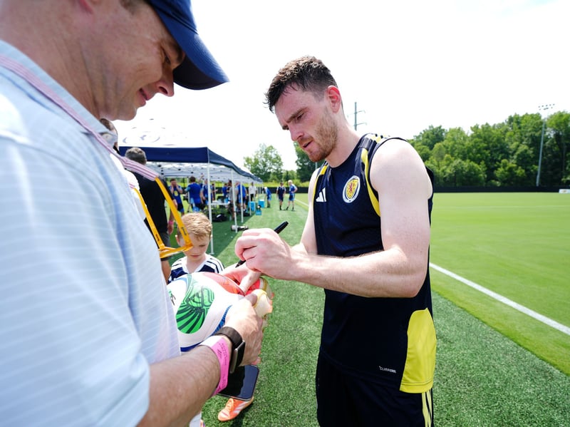 Scotland's Andy Robertson signs autographs while training in North Carolina.