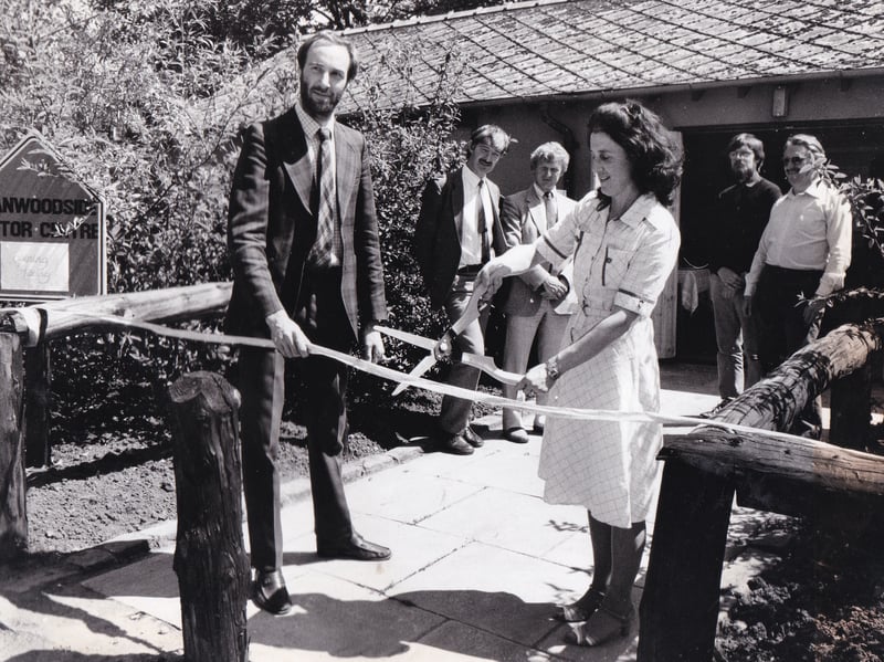 The chairman of Leeds Council Leisure Services Committee, Elizabeth Nash, cuts the tape at the opening of a new visitor centre in the Meanwood Valley in May 1985 watched by the area's countryside warden Philip Thompson.