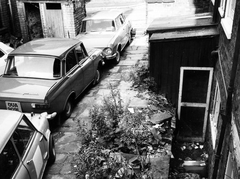 A derelict property in Queen Square awaiting demolition. Cars are parked on the stone flags. Pictured in October 1974.