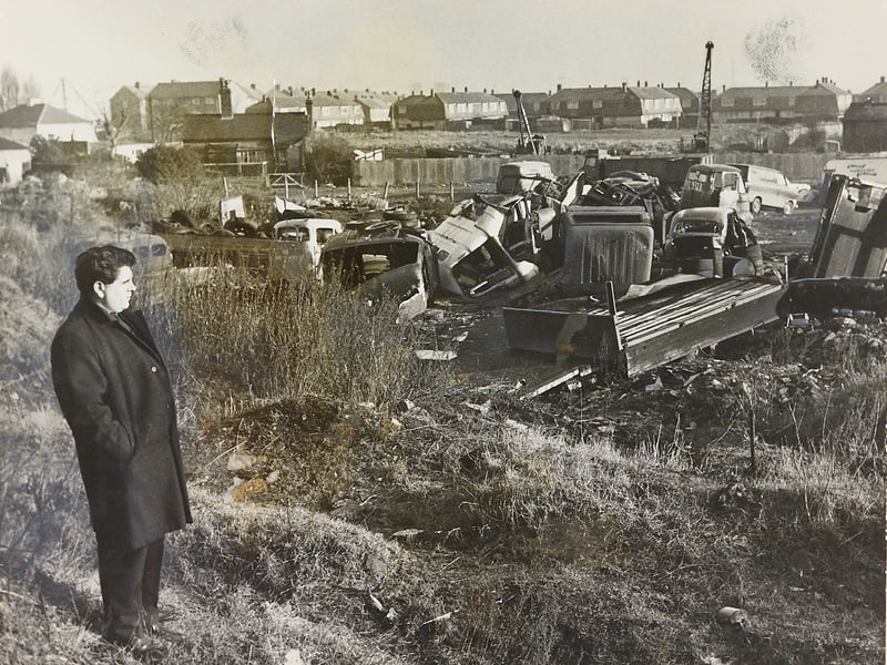 Councillor Dennis Turner looks across a cluttered scrapyard site on Walter Road, Bilston, in 1969, protesting against local authority proposals to construct public toilets on the historic plot. Revered as the "Heart of the Black Country", the land holds tremendous heritage value as the place where pioneering industrialist John Wilkinson erected Britain's first blast furnace in 1767. The young councillor's campaign highlighted a passionate push to protect key historical landmarks from inappropriate development across Wolverhampton. Do you remember Dennis Turner's early campaigning efforts or the debate surrounding the historic Walter Road site?