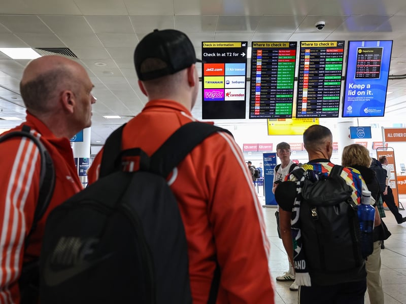 Scotland fans are pictured checking the departures board at Glasgow Airport as they travel to the United States.