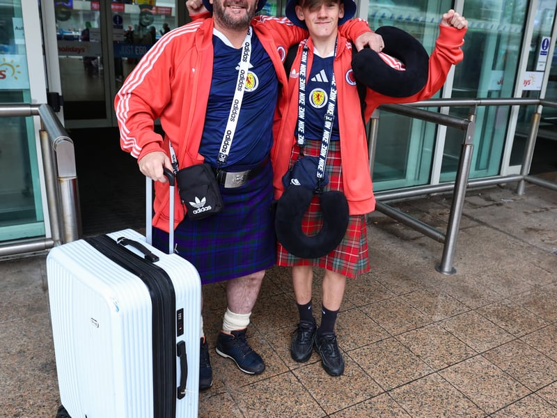Two Scotland fans on their way to the World Cup at Glasgow Airport.