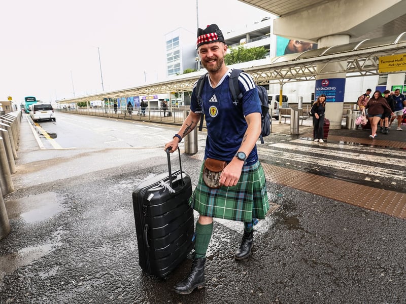 Scotland fans are pictured at Glasgow Airport.