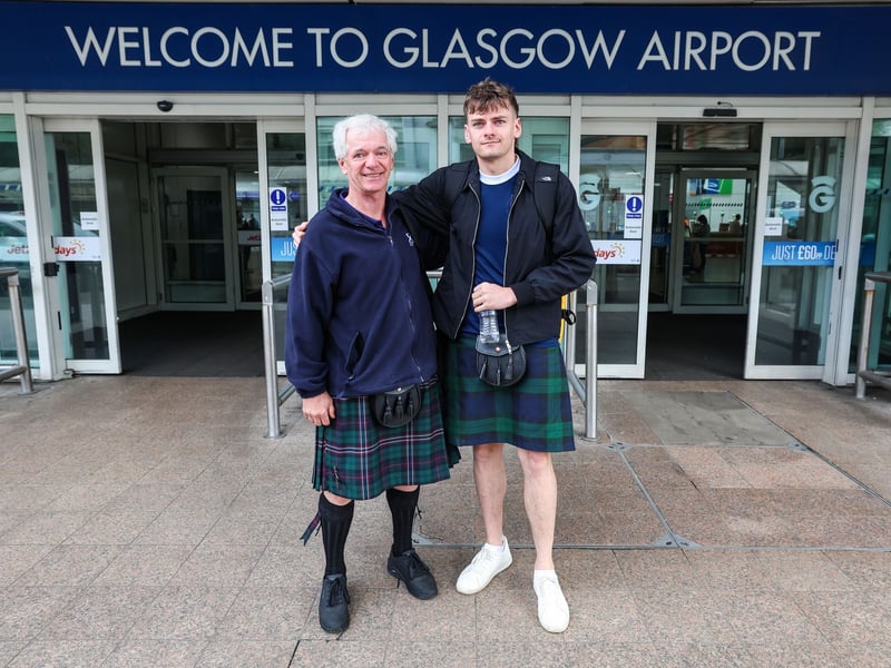 Two Scotland fans dress for the occasion as they head to the World Cup.