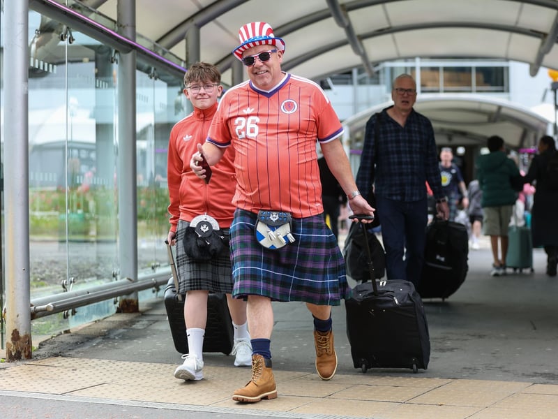 Scotland fans make their way to the departure lounge at Edinburgh Airport.