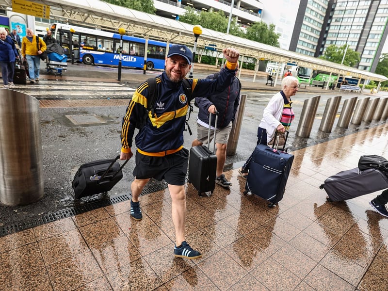 Scotland fans are pictured at Glasgow Airport.
