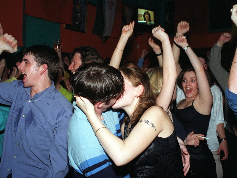 A couple kiss while World Cup watchers at at the Observatory in Leeds city centre celebrate England beating Columbia.