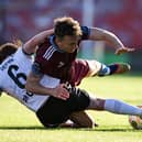 Galway United's Ed McCarthy is tackled by Aodh Dervin of Dundalk in Turner's Cross Stadium in Cork.