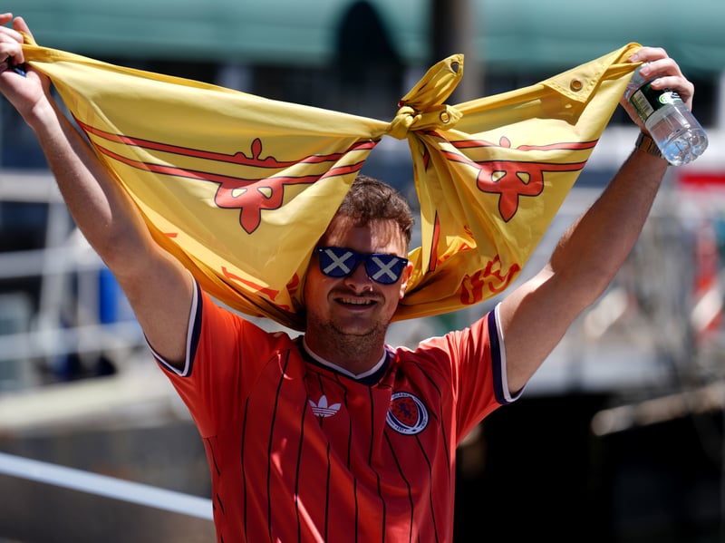 A Scotland fan disembarks after sailing on the Lexington boat cruise in Boston Harbour
