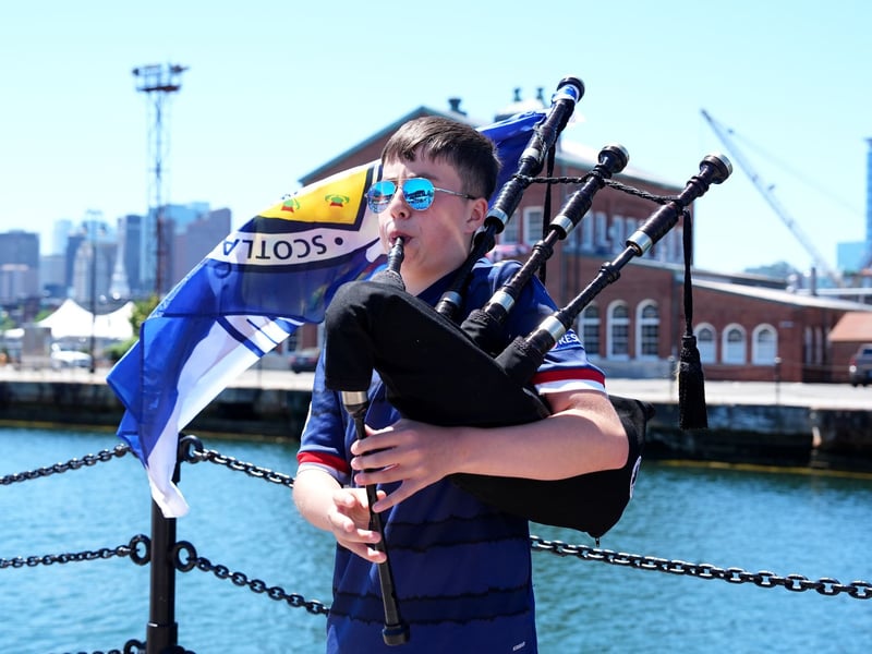 Scotland fan Finlay Ramsay playing the bagpipes outside The Anchor