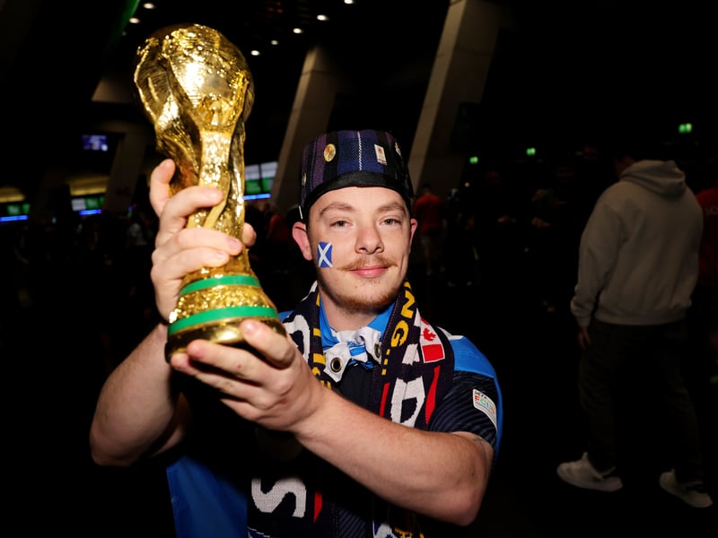 A Scotland fan with a replica World Cup trophy at the Hydro