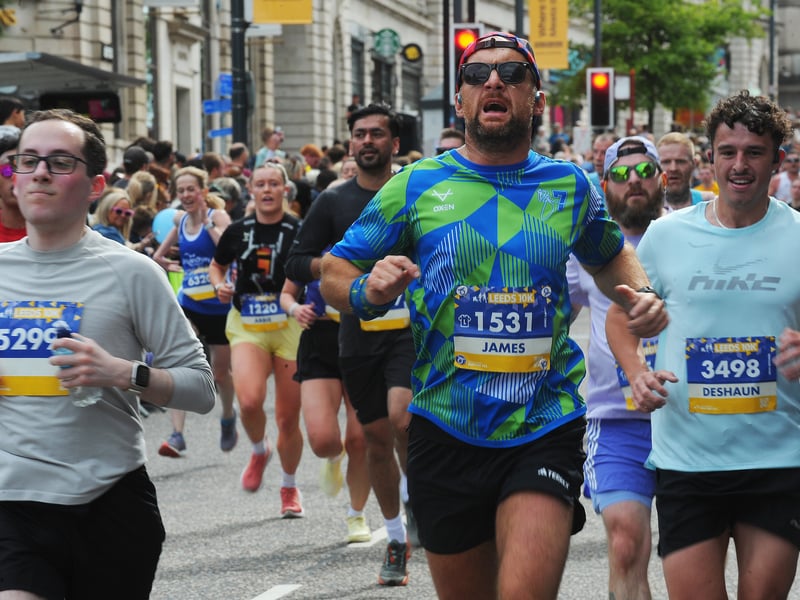 More finishers of the Leeds 10k passing through the Headrow.